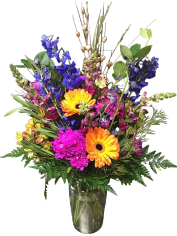 A vase filled with colorful flowers on top of a table.