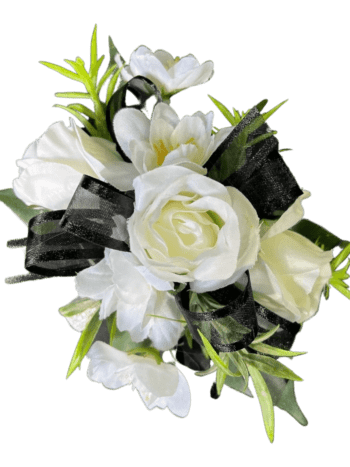 A white rose corsage with black ribbon.