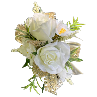 A white rose corsage with greenery and gold leaves.