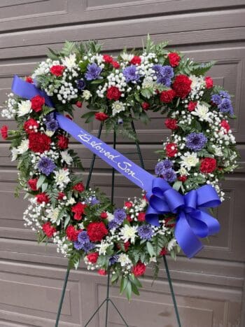 A wreath of flowers with the words " happy birthday " on it.