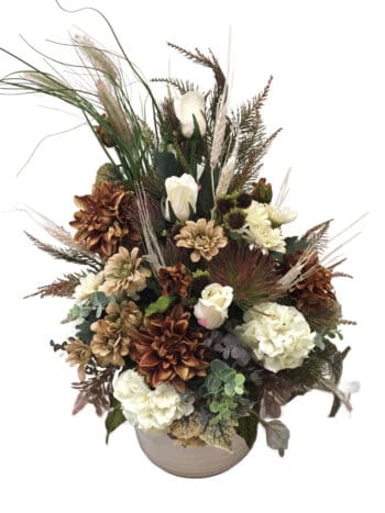 A bouquet of flowers and feathers in a vase.