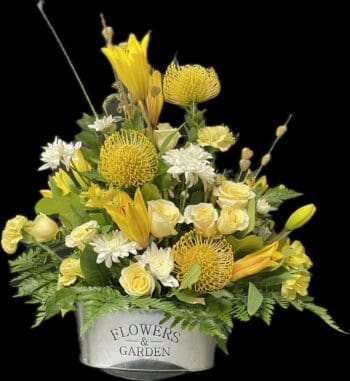 A bouquet of flowers in a metal container.