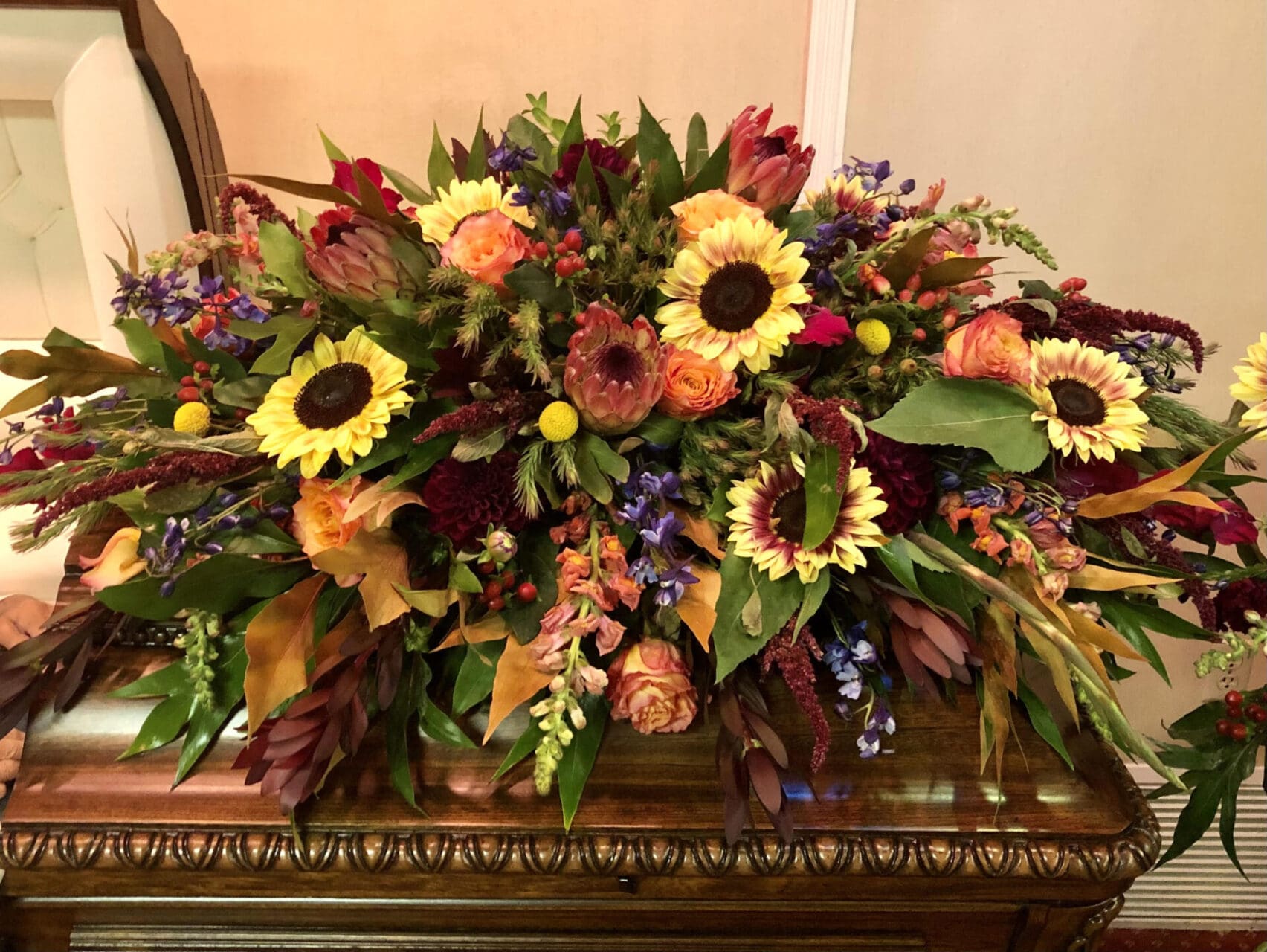 Floral arrangement on a wooden casket.