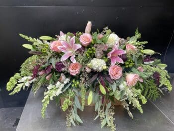 Pink and white floral arrangement with birds.